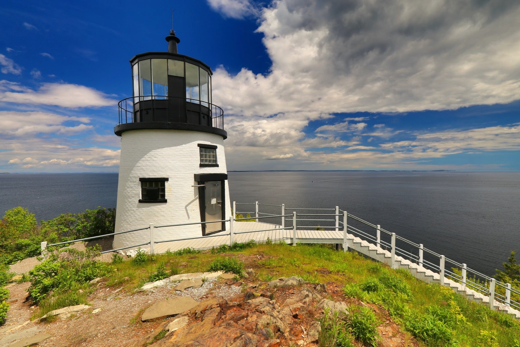 Black and white lighthouse along the water